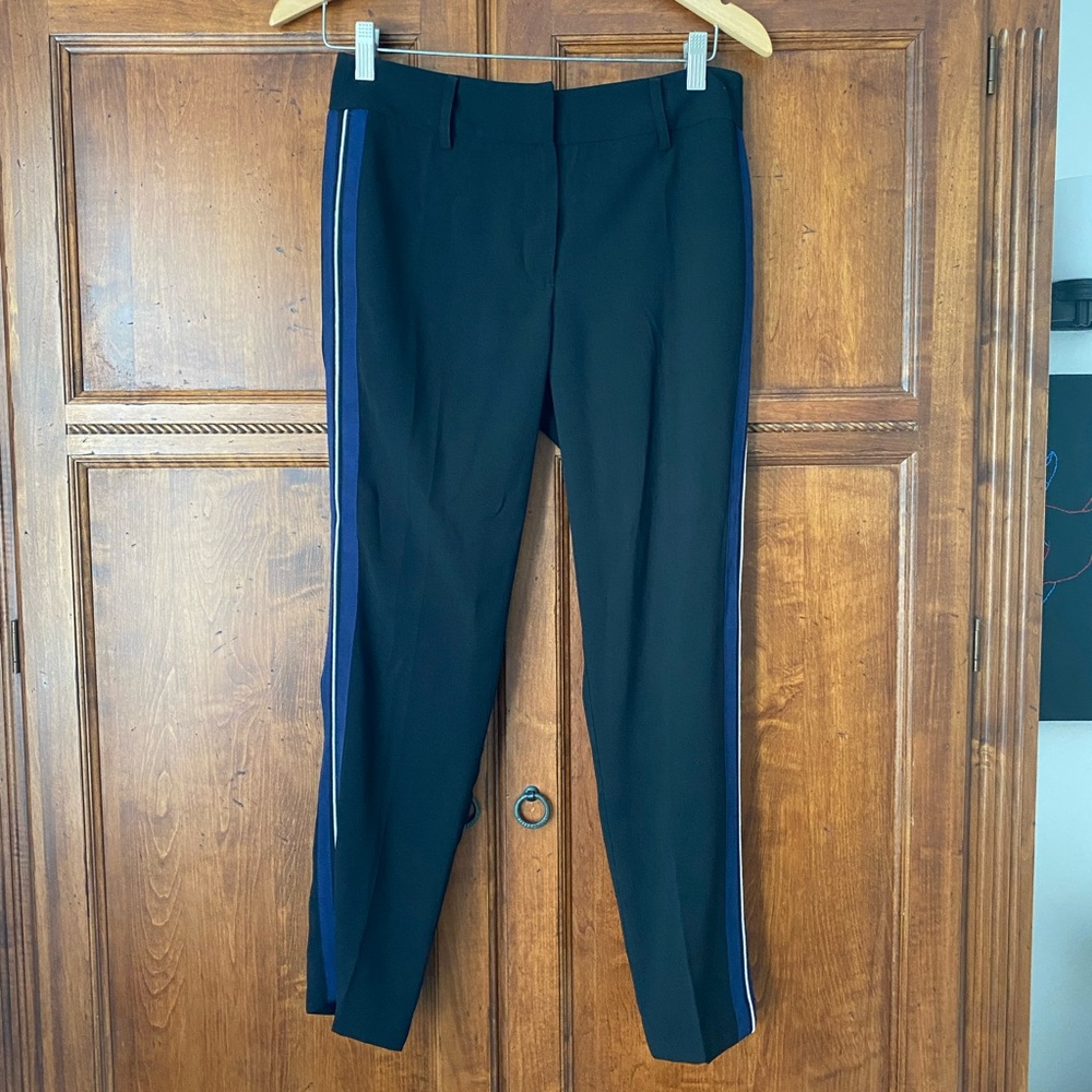 Black trousers with blue and white stripe down the side of the leg